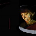 False Assumption, 2013 --- My Mother's face from a family photograph projected back on to her face. 92 X 64cm Photography; C-type lambda print, aluminium mounted and box framed in black
