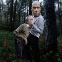 Reclaiming, 2011 --- Father and self wearing wooden mask of Father's head 106 x 156cm Photography; C-type Lambda print, framed in white