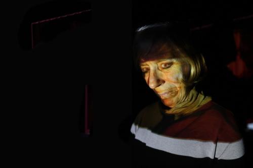 False Assumption (my mum's face from old family photo projected back onto her face), 2012