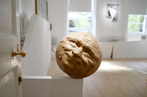 Crutch (17kg wooden mask with father's face that closes around my knee to my exact proportions, weighing me to the ground), Maple wood, 42cm diameter, 2021