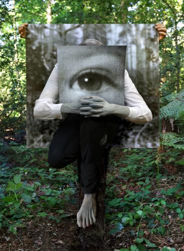 Untitled (self painted grey, cradling photograph of eye as a child, obscuring my own eyes, in front of backdrop held by partner), 116 x 85cm, Photograph mounted and box framed in black, 2016